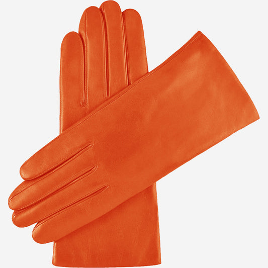 Pair of orange leather gloves on a white background