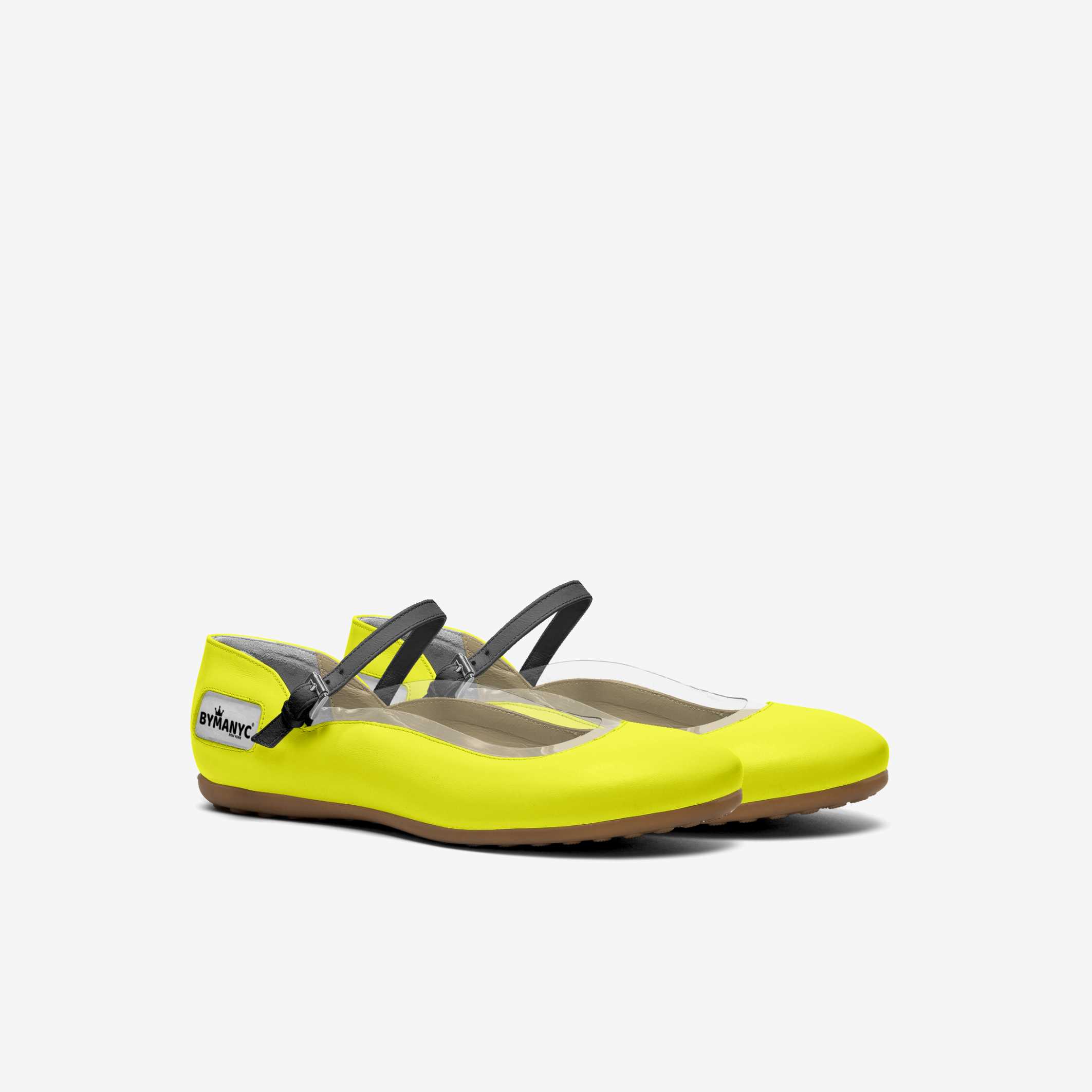 Yellow flat shoe with black strap on a white background