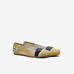 Pair of yellow flats with a black bow on a white background