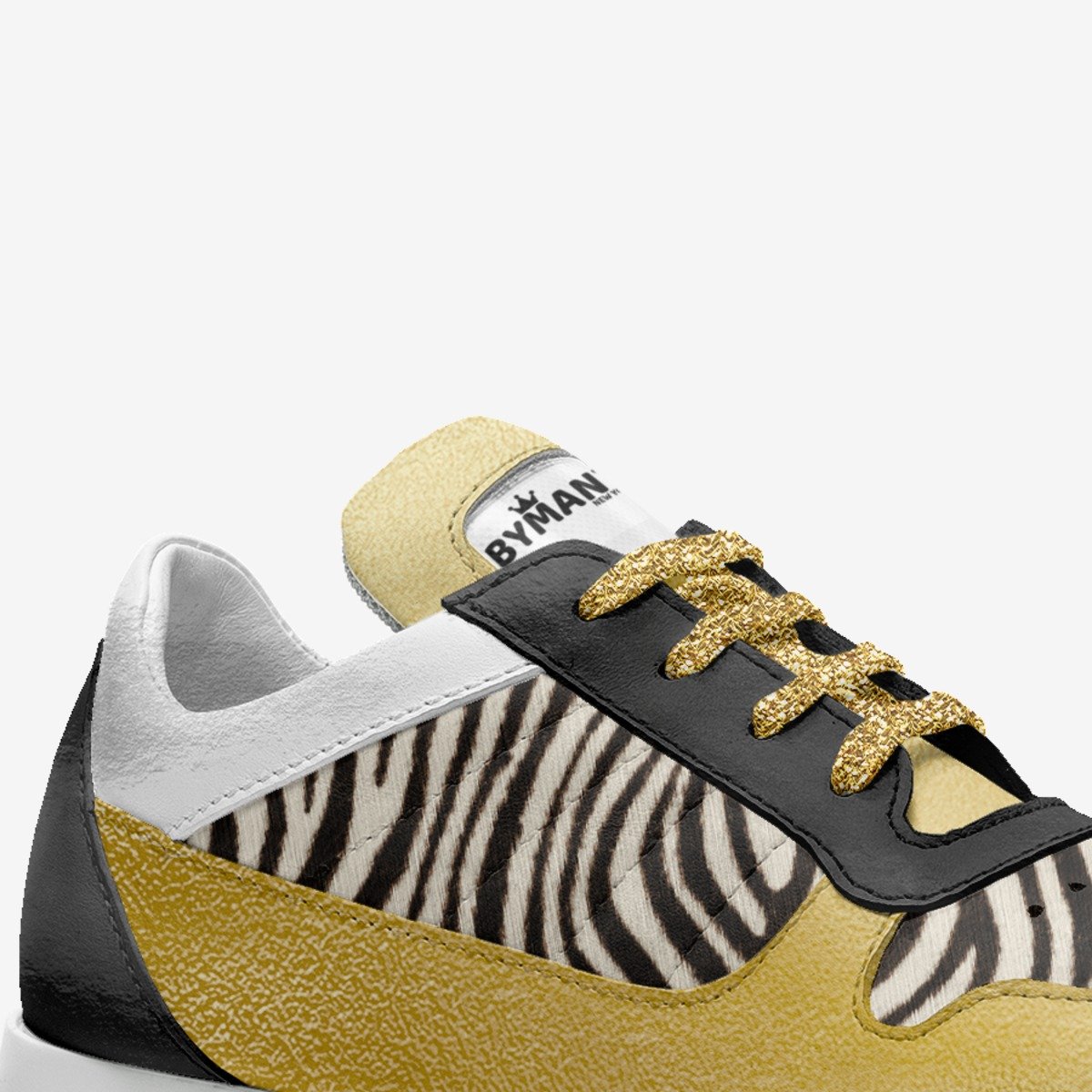Sneaker with zebra pattern and gold accents on a white background