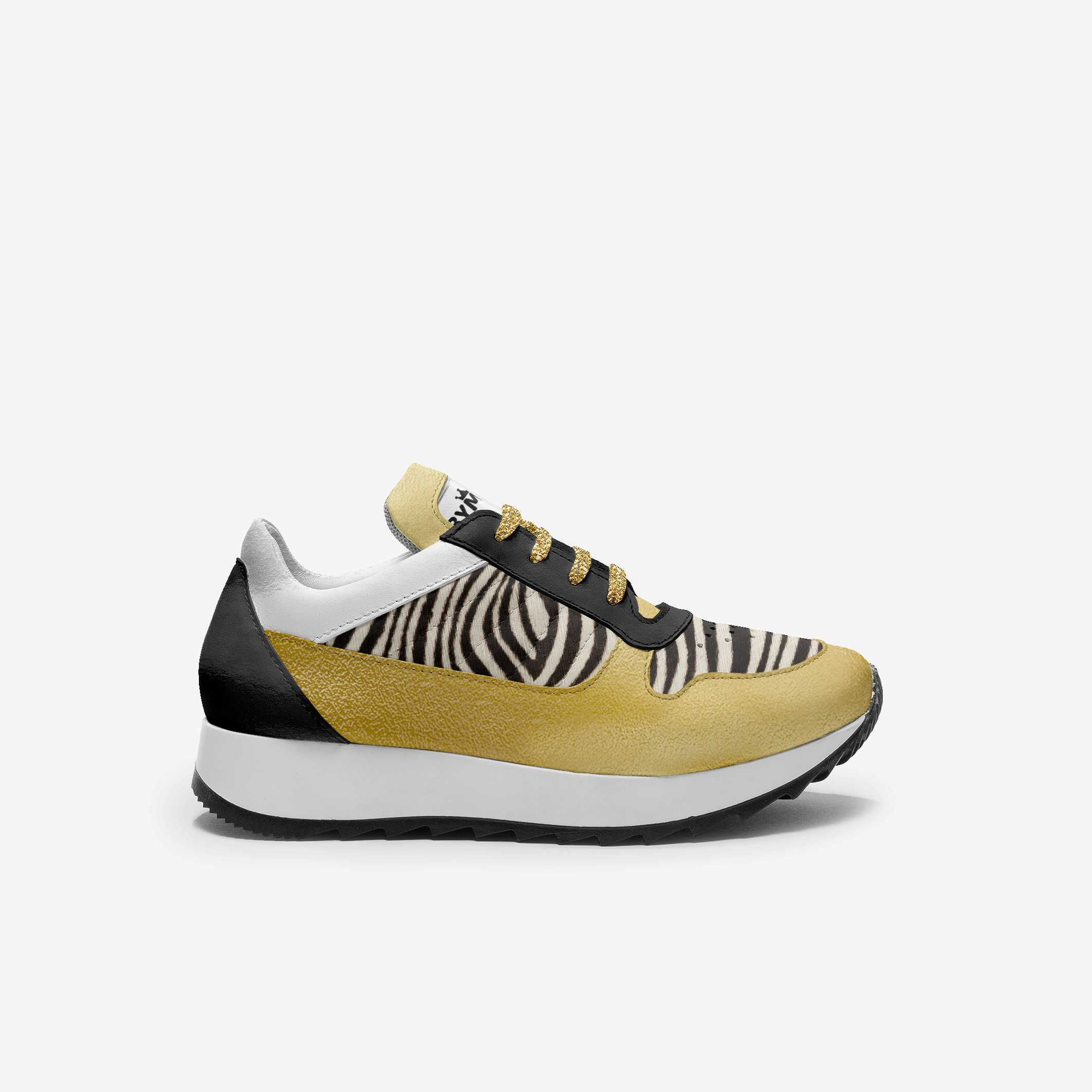 Sneaker with zebra pattern and gold accents on a white background