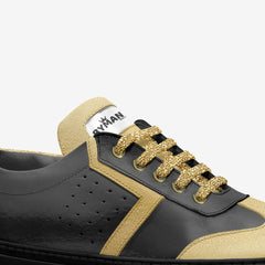 Black and gold sneaker with 'Ryman' branding on a white background