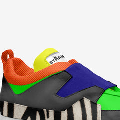 Colorful sneaker with zebra pattern sole on a white background