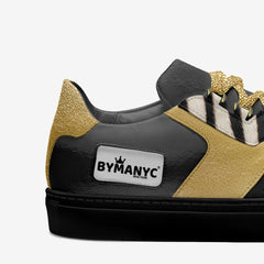 Close-up of a sneaker with 'BYMANYC' branding on a white background
