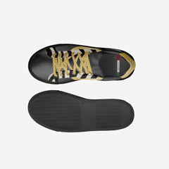 Black sneaker with gold and white accents on a light gray background