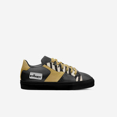 Black and gold sneaker with 'BYMANYC' branding on a white background