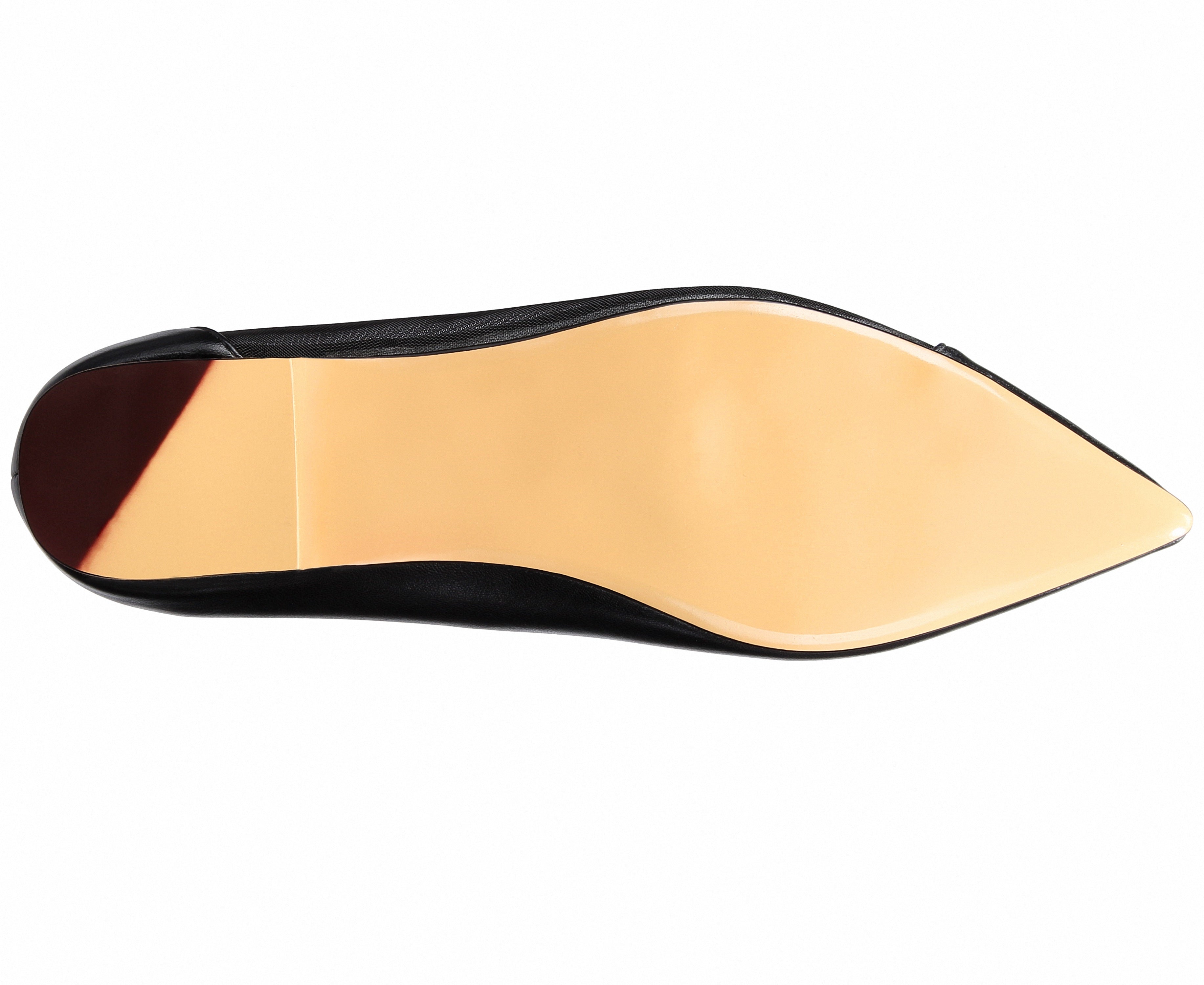 Close-up of a shoe sole with a black outer rim and beige inner lining on a white background