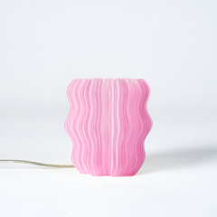 Pink wavy-patterned lamp on a white background