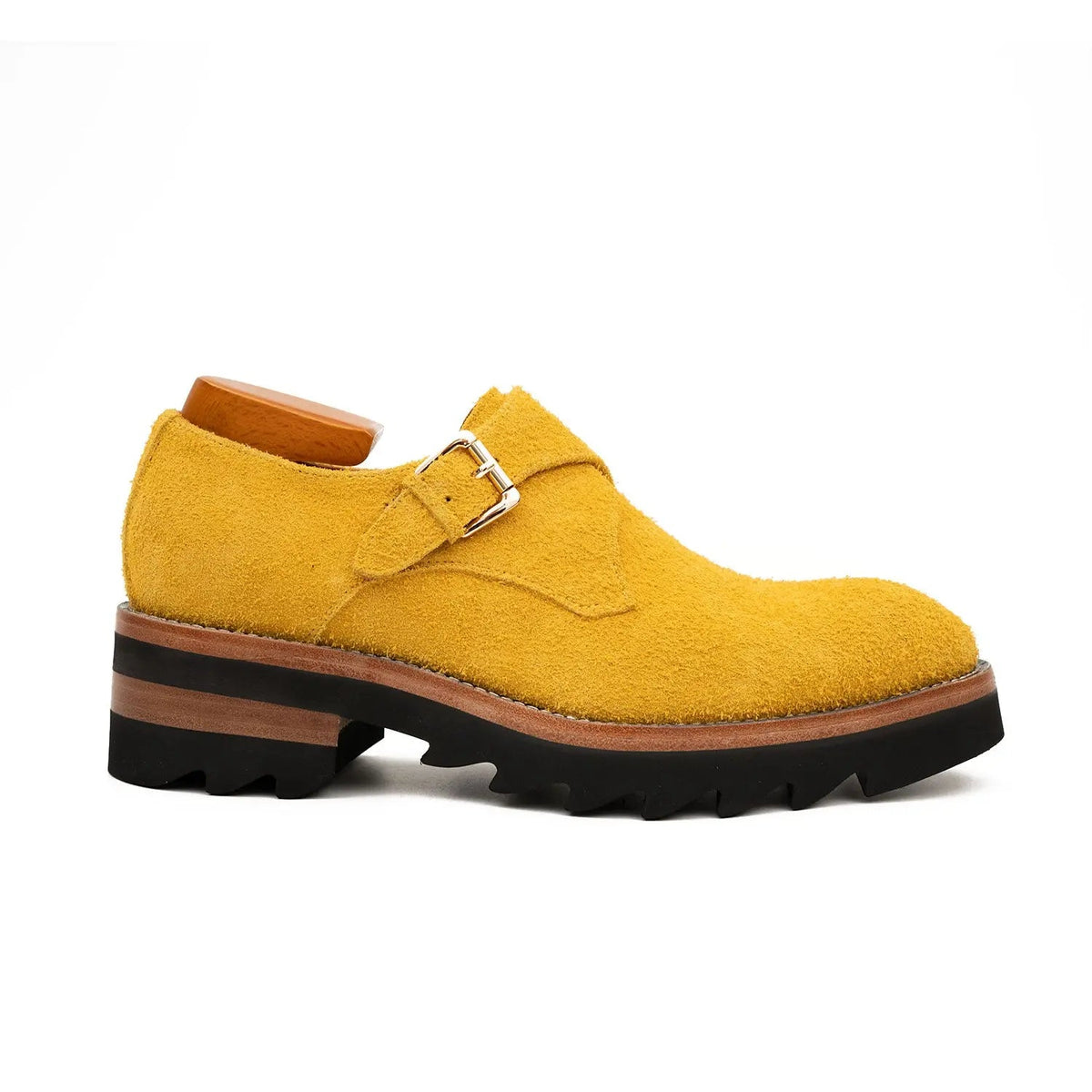 Yellow suede shoe with a brown sole on a white background