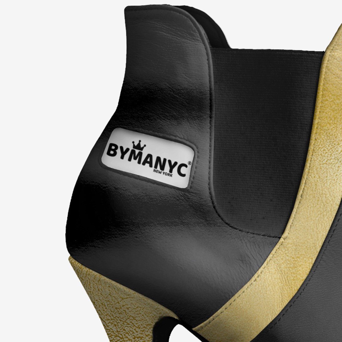 Black and gold shoe with 'BYMANYC' logo on a white background