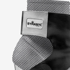 Black and white patterned tie with ByManyC label on a white background