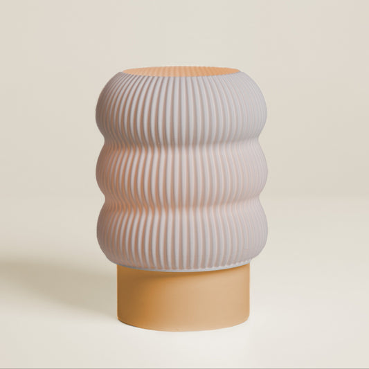Decorative vase with ribbed design on a beige background
