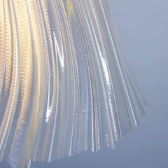 Metallic pleated fabric against a blue sky