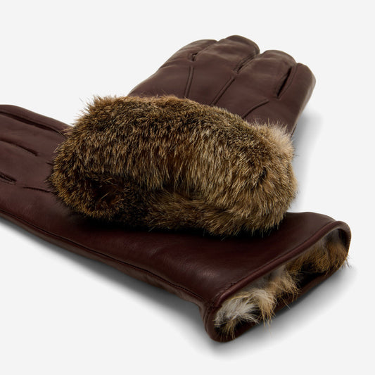Brown leather gloves with fur cuffs on a white background