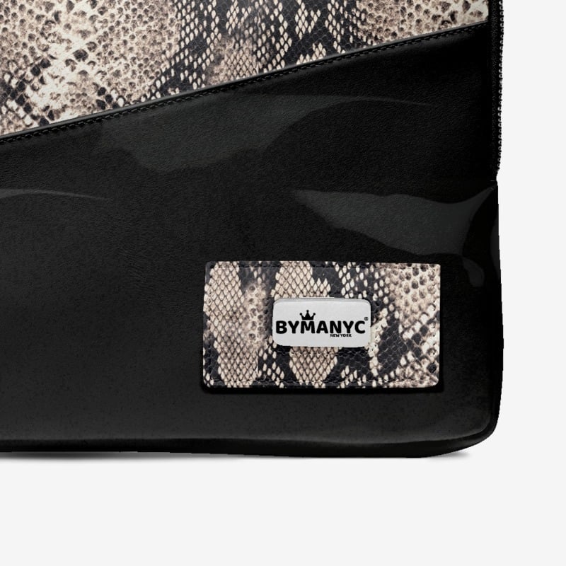 Black handbag with snake print patch featuring 'BYMANYC' logo on a white background
