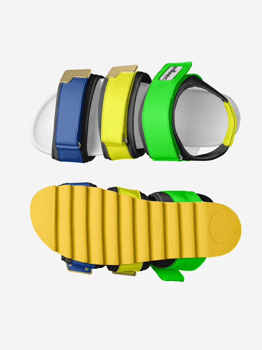 Colorful slide sandals with different strap designs on a white background