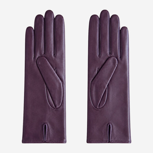 Pair of purple leather gloves on a light gray background