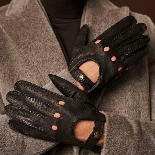 Black leather gloves with fingerless design worn by a person in a gray coat.