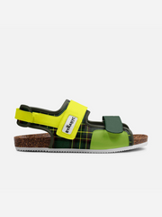 Green and yellow sandal with cork sole on a white background