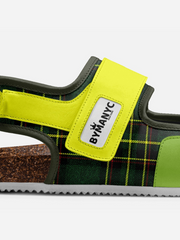 Green sandal with a yellow strap featuring 'Bymancy' branding on a white background