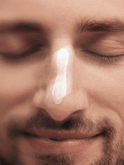 Close-up of a man's face with a droplet on his nose