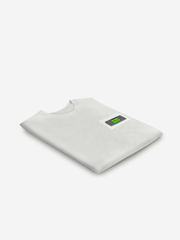 White t-shirt with a small green label on a white background
