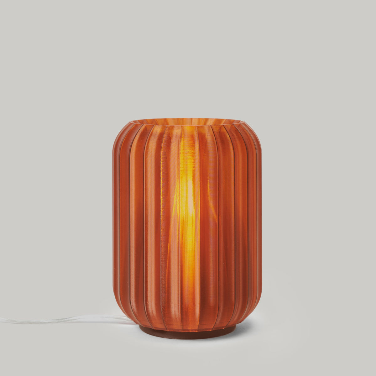 Decorative lamp with ribbed design on a plain background