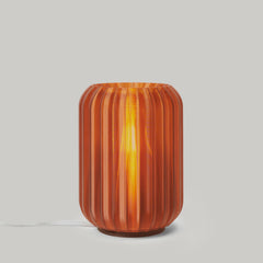 Decorative lamp with ribbed design on a plain background