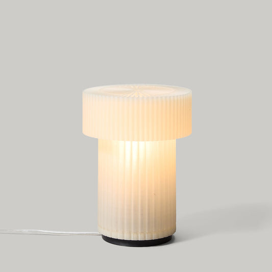 Table lamp with ribbed design on a gray background