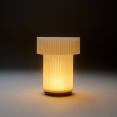 Decorative lamp with ribbed design on a dark background