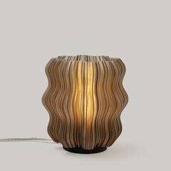 Wavy-patterned table lamp on a plain background
