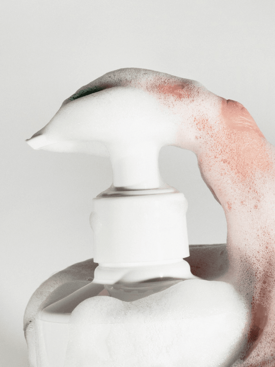 White ceramic vase with a textured surface on a light gray background