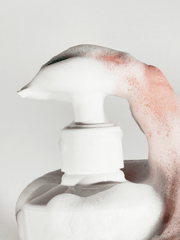 White ceramic vase with a textured surface on a light gray background