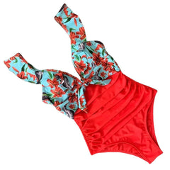 Two-piece swimsuit with floral top and red bottom on a white background