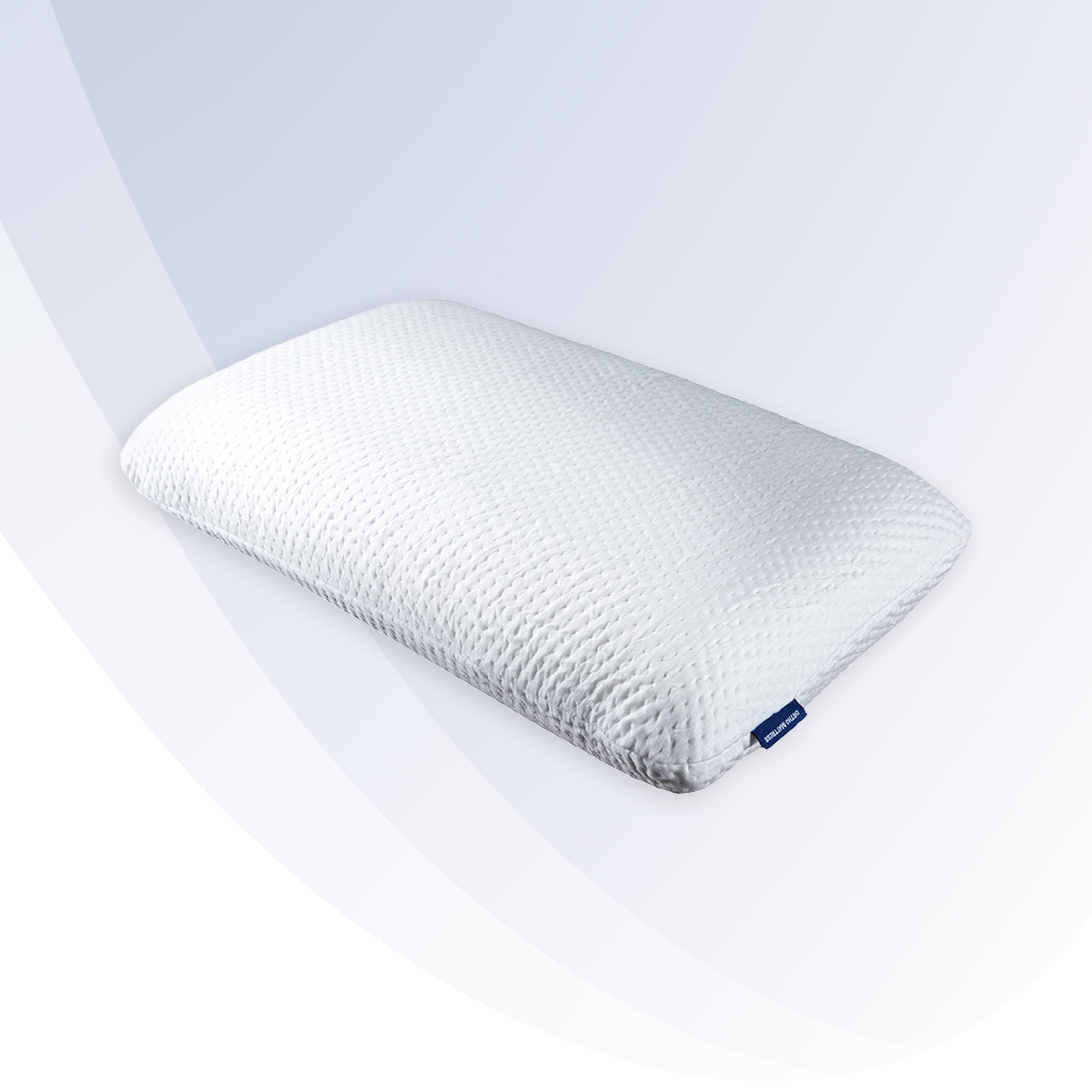 White pillow with a brand logo on a white background