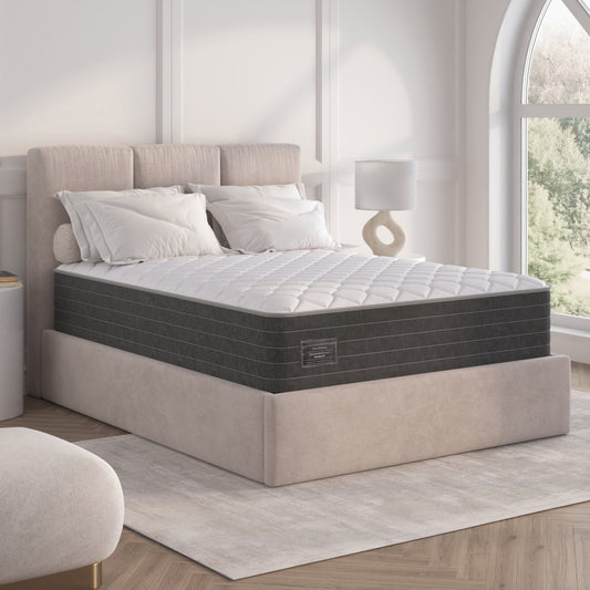 Gray mattress on a bed frame in a bedroom setting