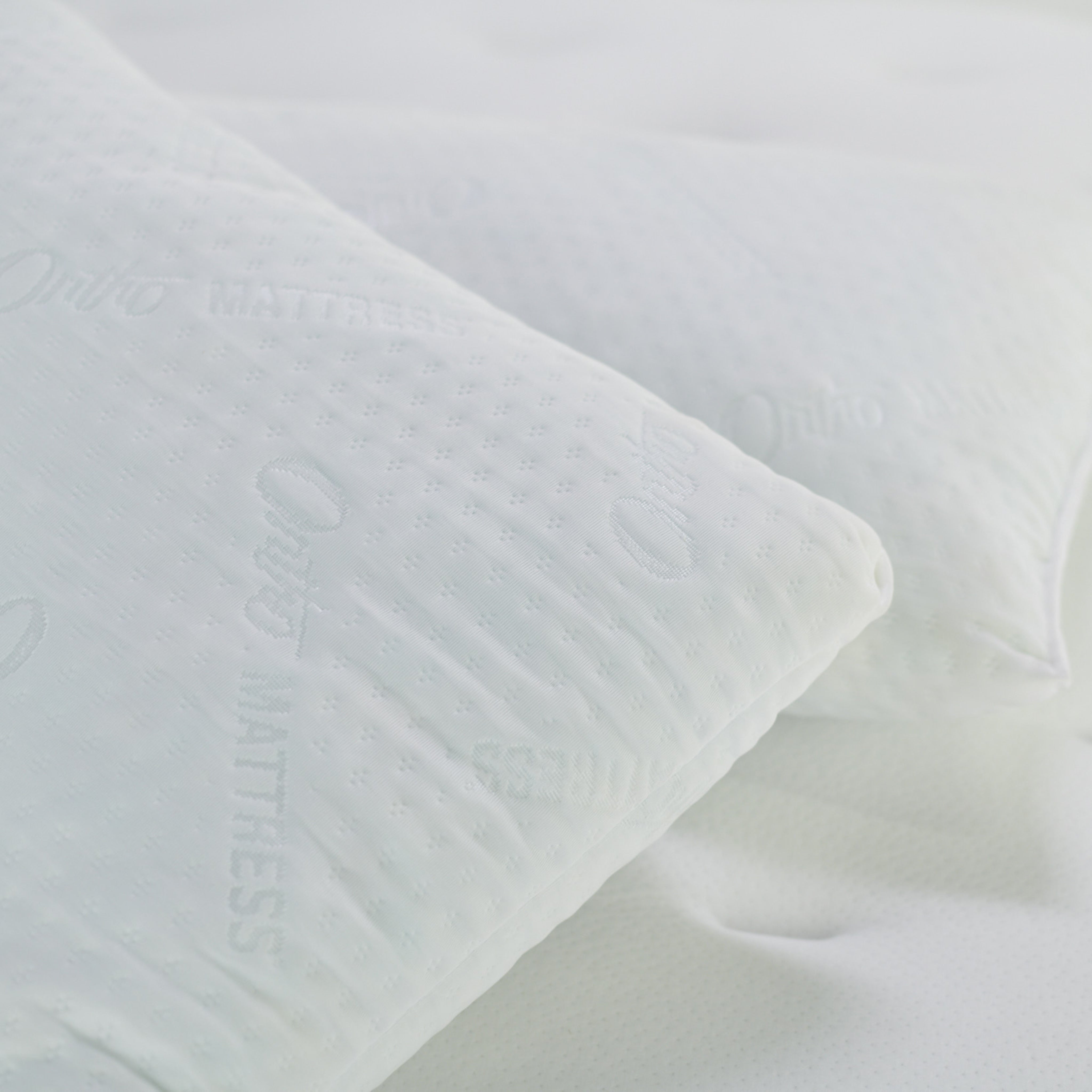 White textured fabric on a light gray background