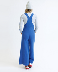 Person wearing a blue jumpsuit on a white background