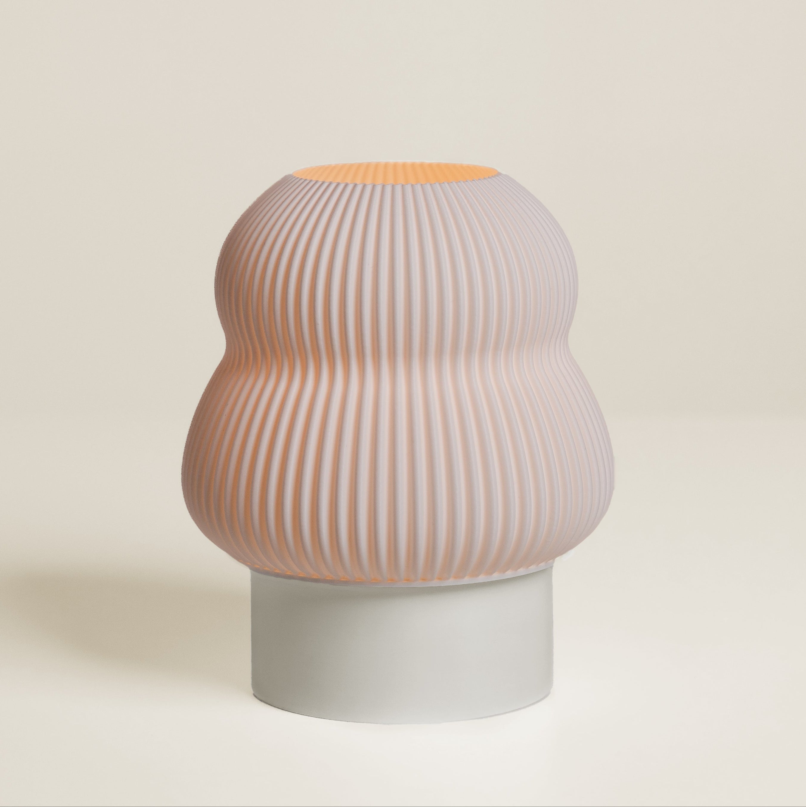 Decorative vase with ribbed design on a plain background