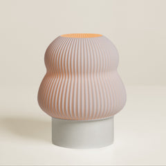 Decorative vase with ribbed design on a plain background