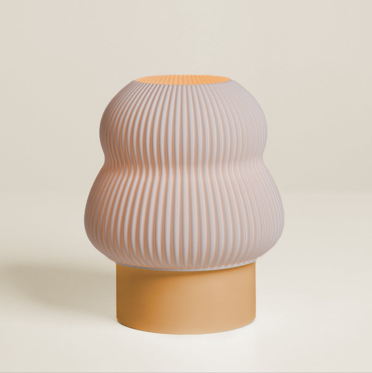 Decorative vase with ribbed design and mustard yellow base on a light beige background
