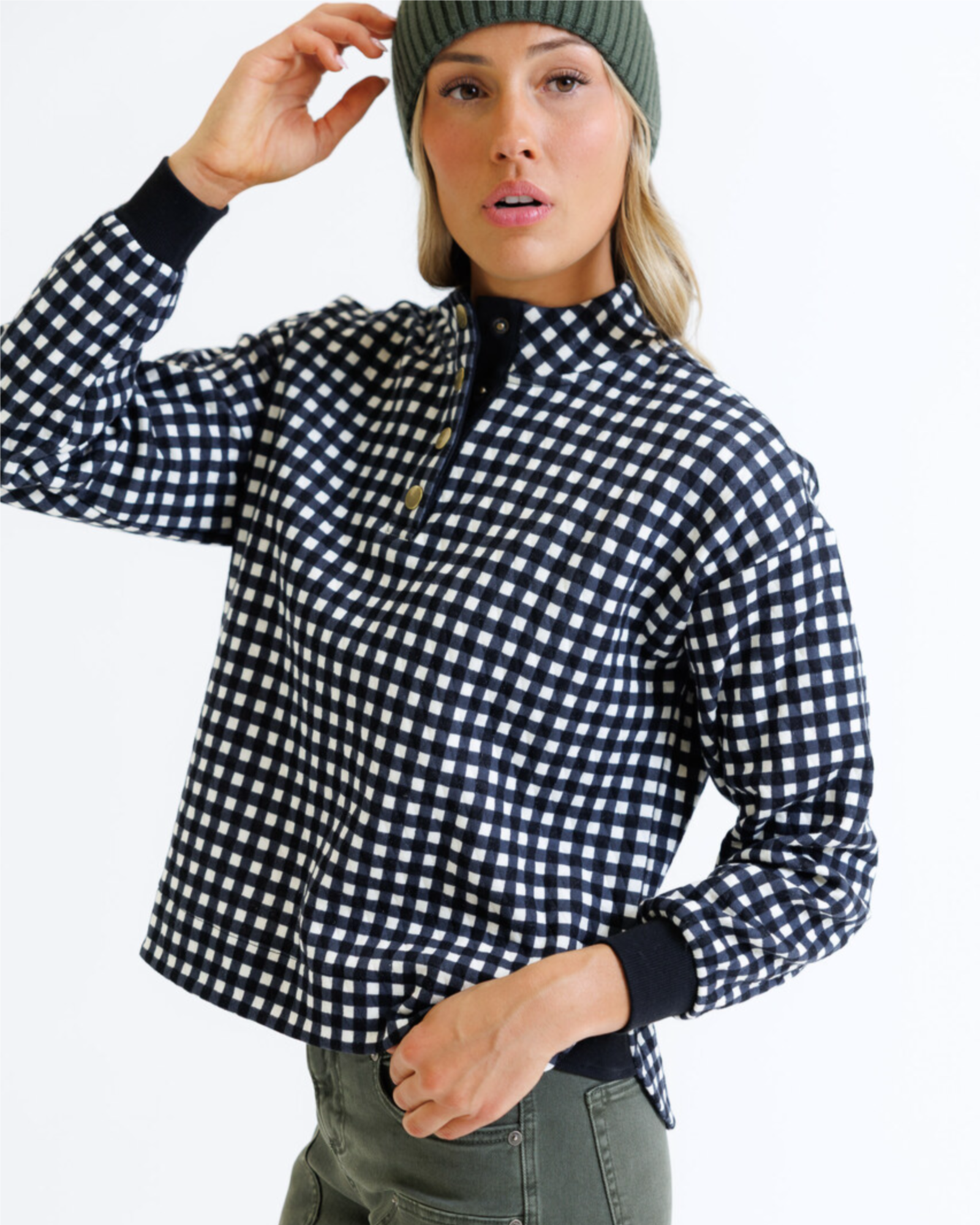 Person wearing a black and white checkered shirt with a plain background