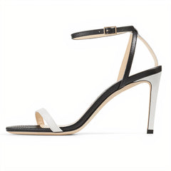 Black and white sandal with thin straps on a white background