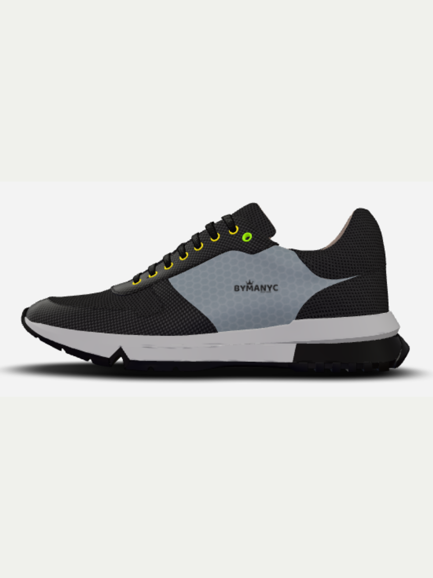 Black and gray sneaker with yellow accents on a light gray background