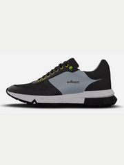 Black and gray sneaker with yellow accents on a light gray background