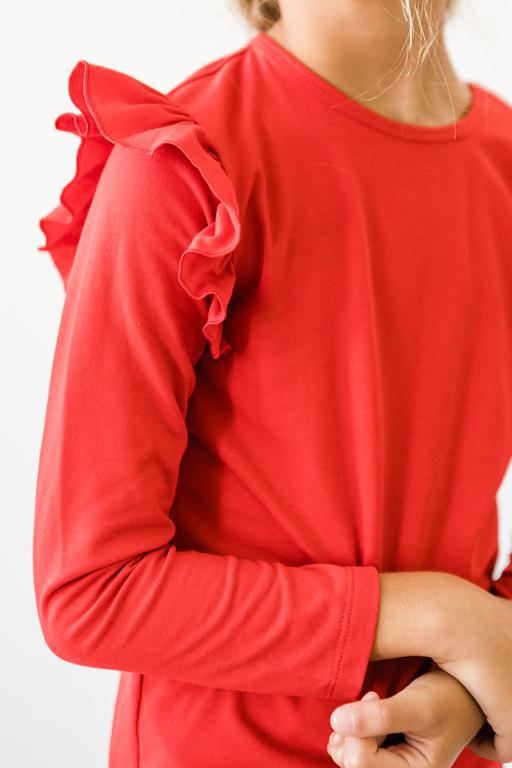 Red long-sleeve top with ruffled shoulders on a white background