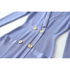 Blue ribbed cardigan with button details on a white background