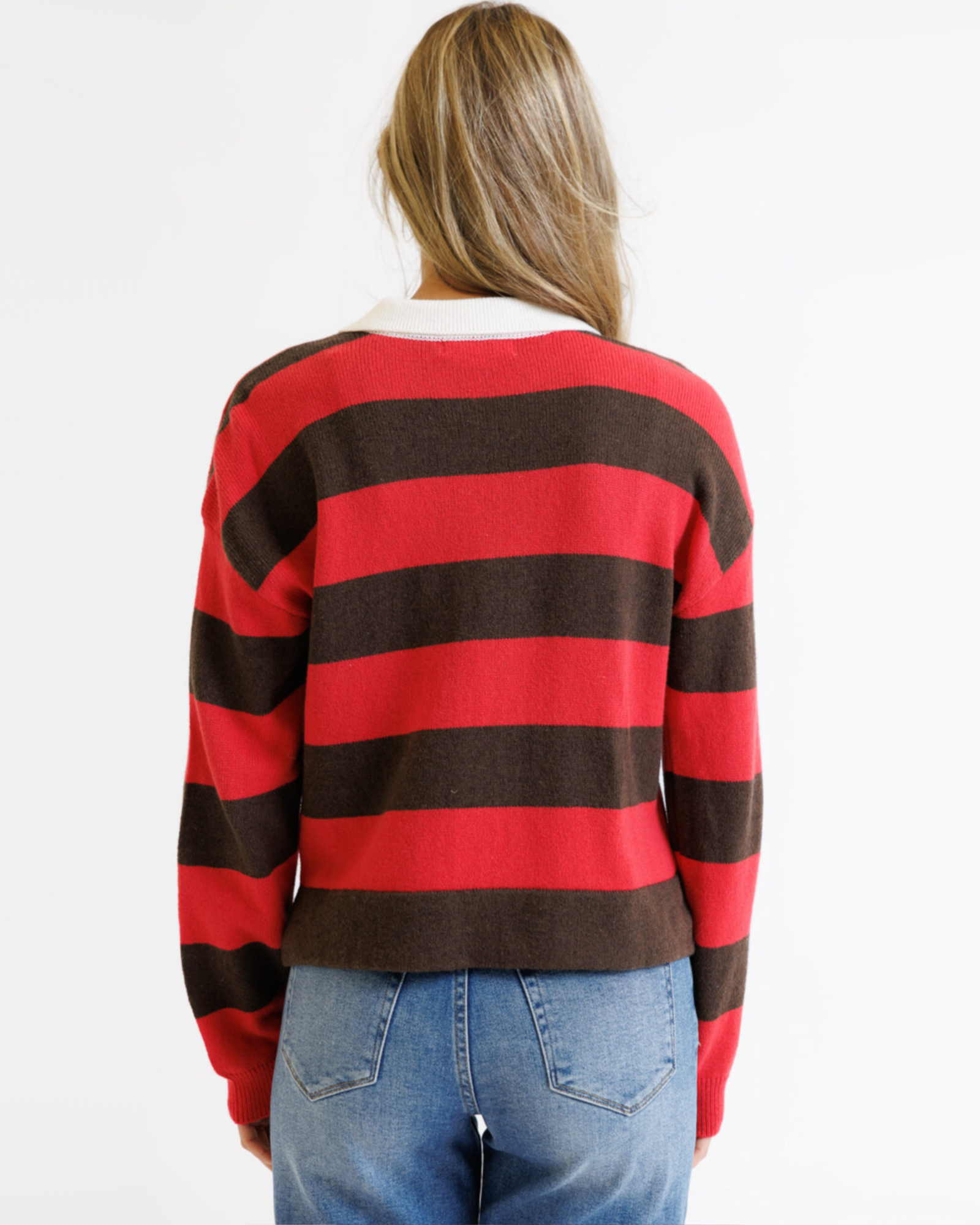 Person wearing a red and brown striped sweater on a white background