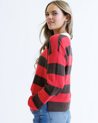 Woman wearing a red and brown striped sweater on a white background