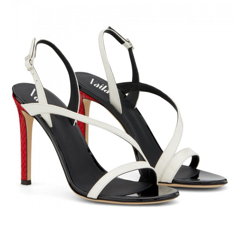 Black and white high-heeled sandals with red soles on a white background